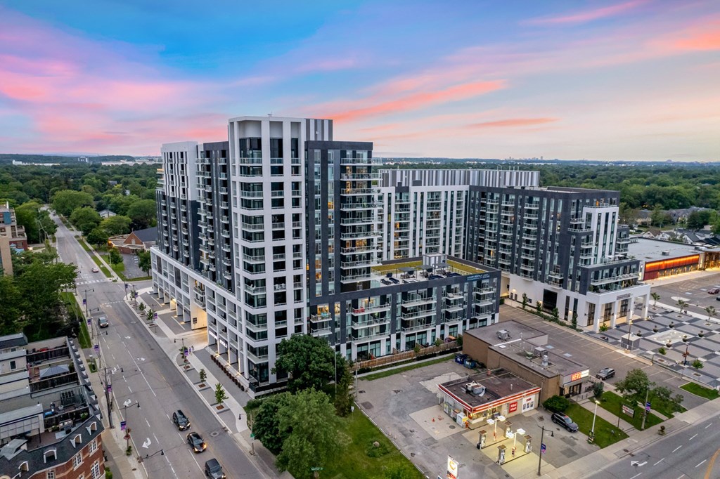 an aerial view of a city with tall buildings and a sunset  at The Village, Oakville
