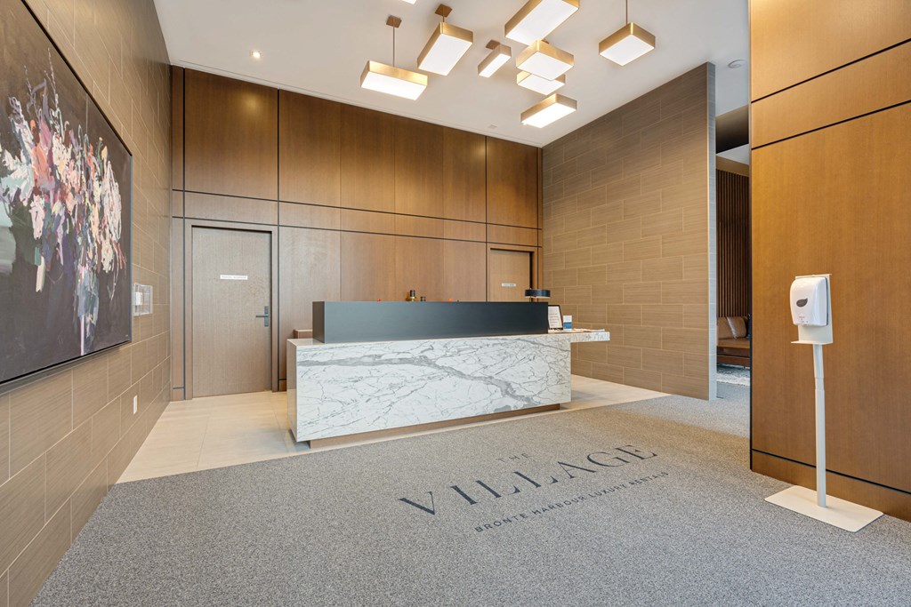 a marble reception desk in a hotel lobby at The Village, Oakville
