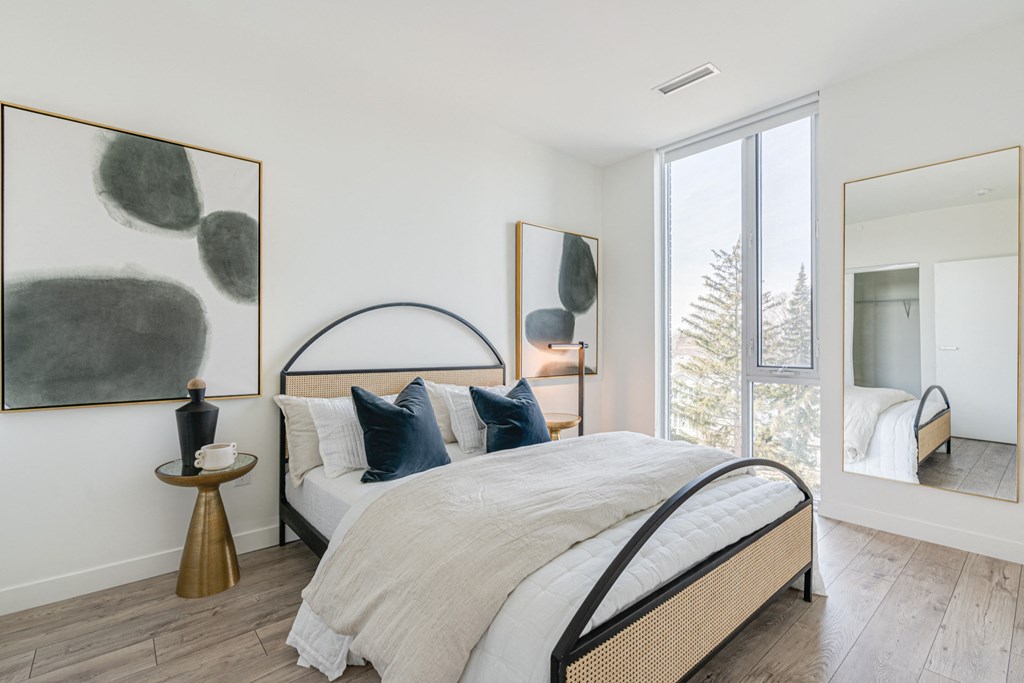 a bedroom with a bed and a large window at The Village, Oakville, ON, L6L 0H1