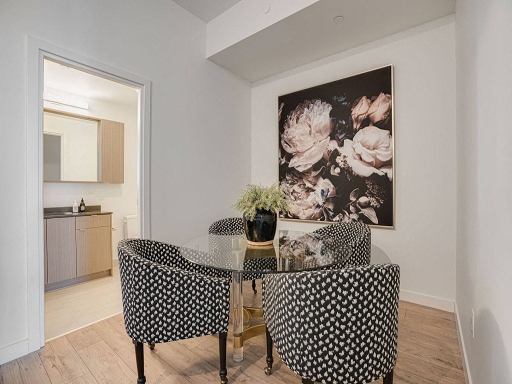 a dining room with a table and chairs and a painting on the wall at The Village, Oakville, L6L 0H1