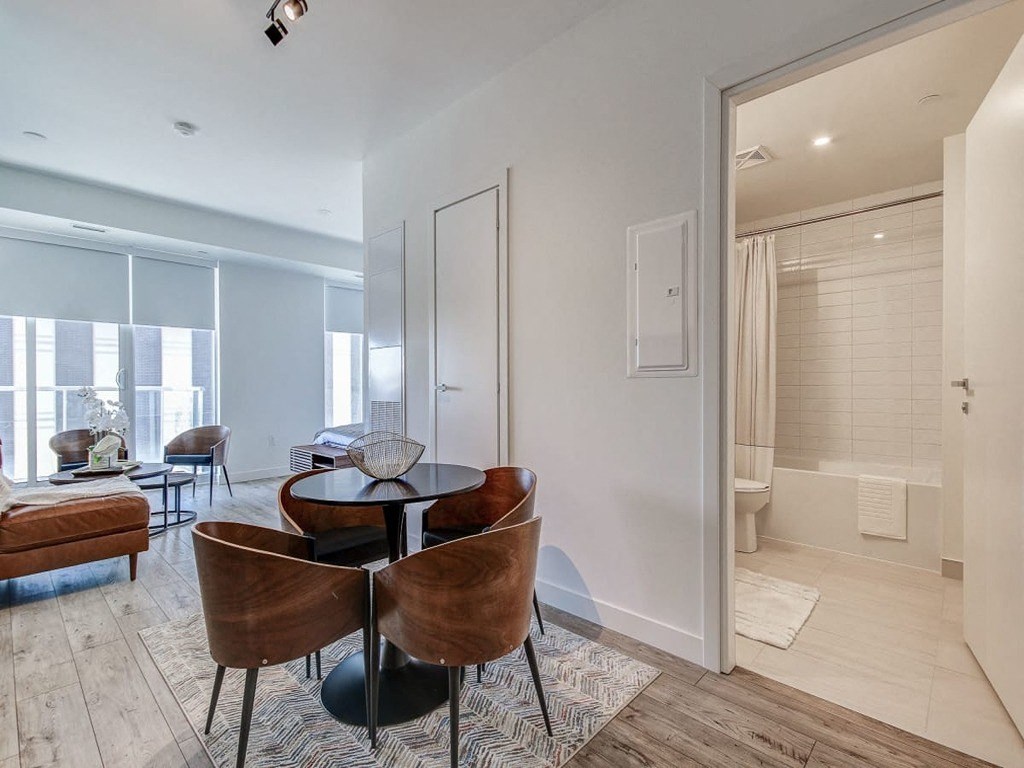 a living room with a table and chairs and a bathroom  at The Village, Oakville, ON, L6L 0H1