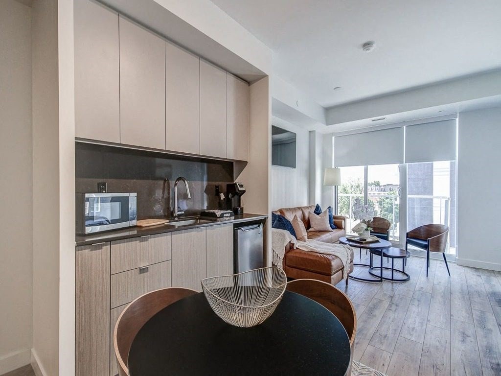 a living room with a kitchen and a couch at The Village, Oakville, L6L 0H1