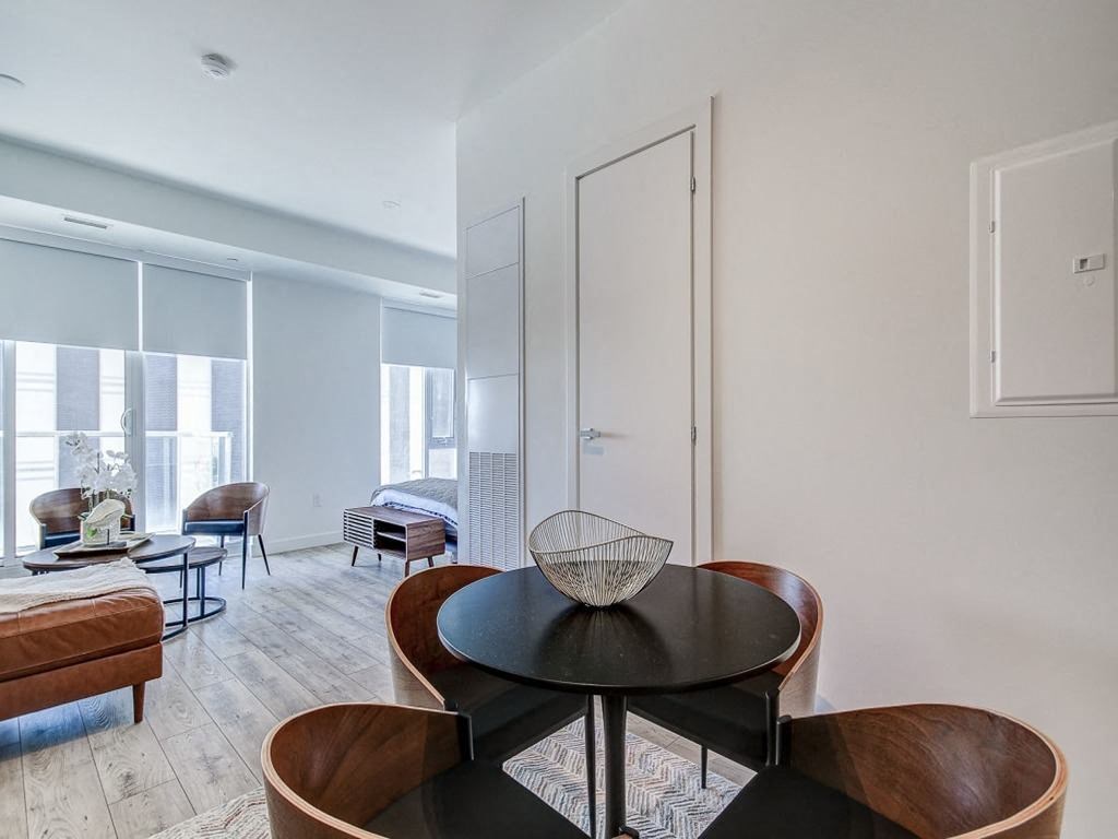 a living room with a table and chairs  at The Village, Oakville, ON