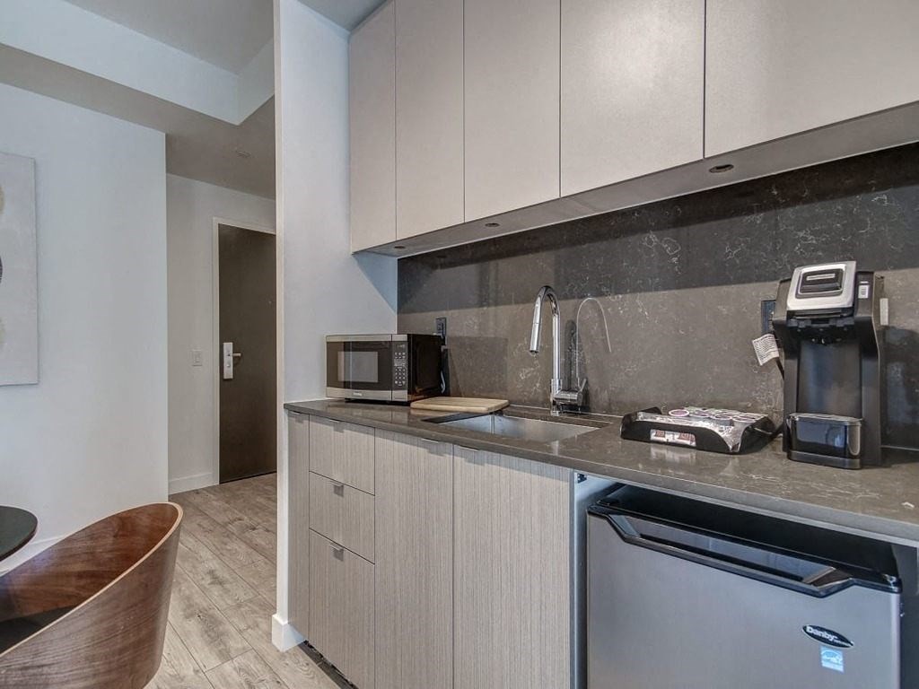 a kitchen with a sink and a dishwasher and a coffee maker  at The Village, Ontario, L6L 0H1