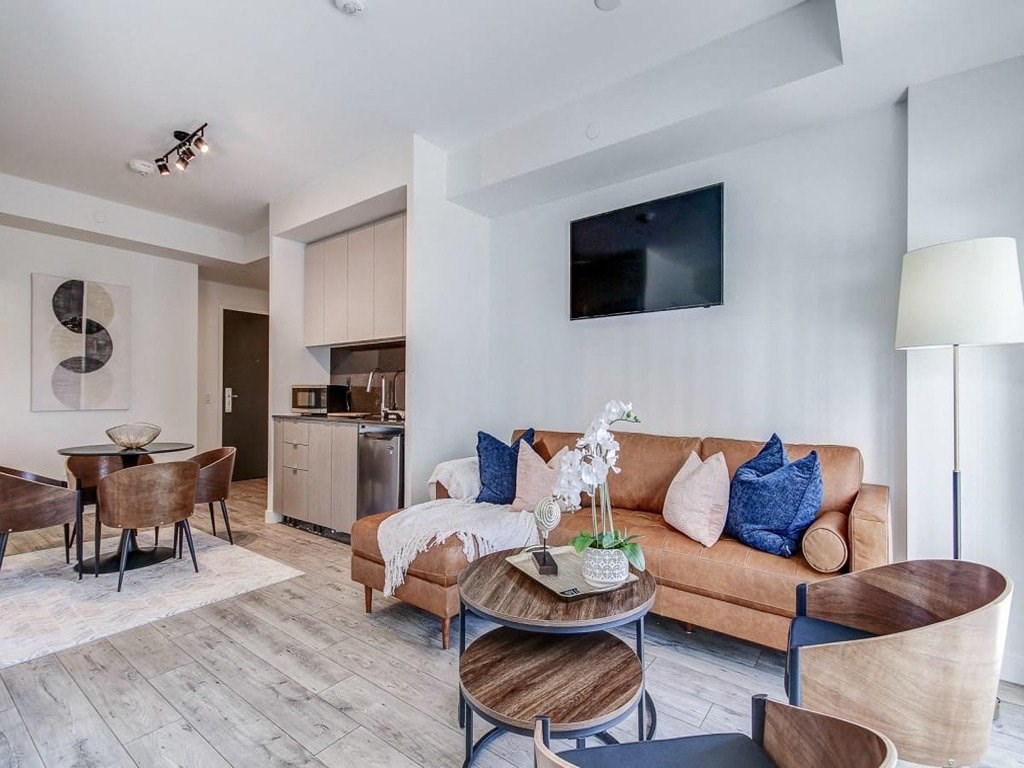 a living room with a couch and a table  at The Village, Oakville, L6L 0H1