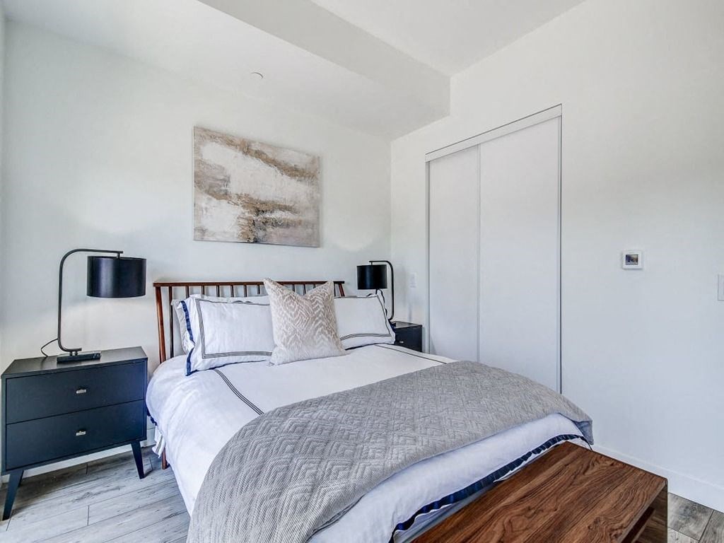 a bedroom with a bed and two night stands  at The Village, Oakville, L6L 0H1