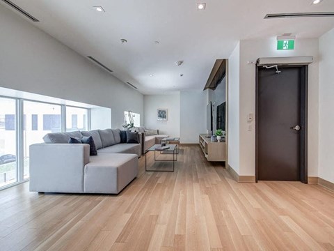 a living room with a couch and a table and a door