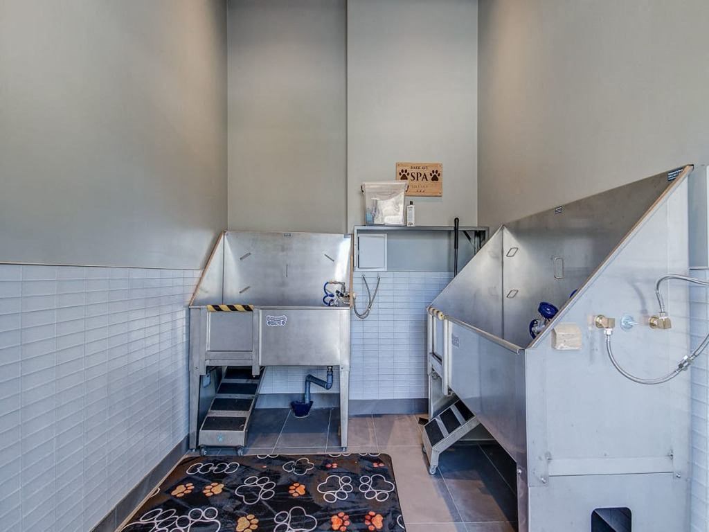 a kitchen with two stainless steel appliances and a black rug at The Village, Oakville, ON