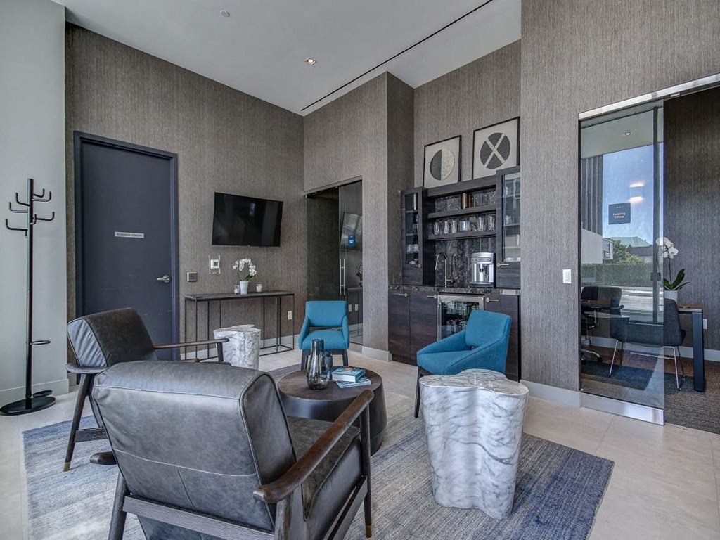 a living room with a couch and chairs and a television at The Village, Ontario, L6L 0H1