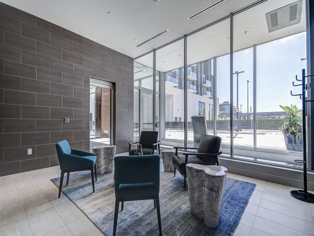 a living room with chairs and a rug at The Village, Ontario