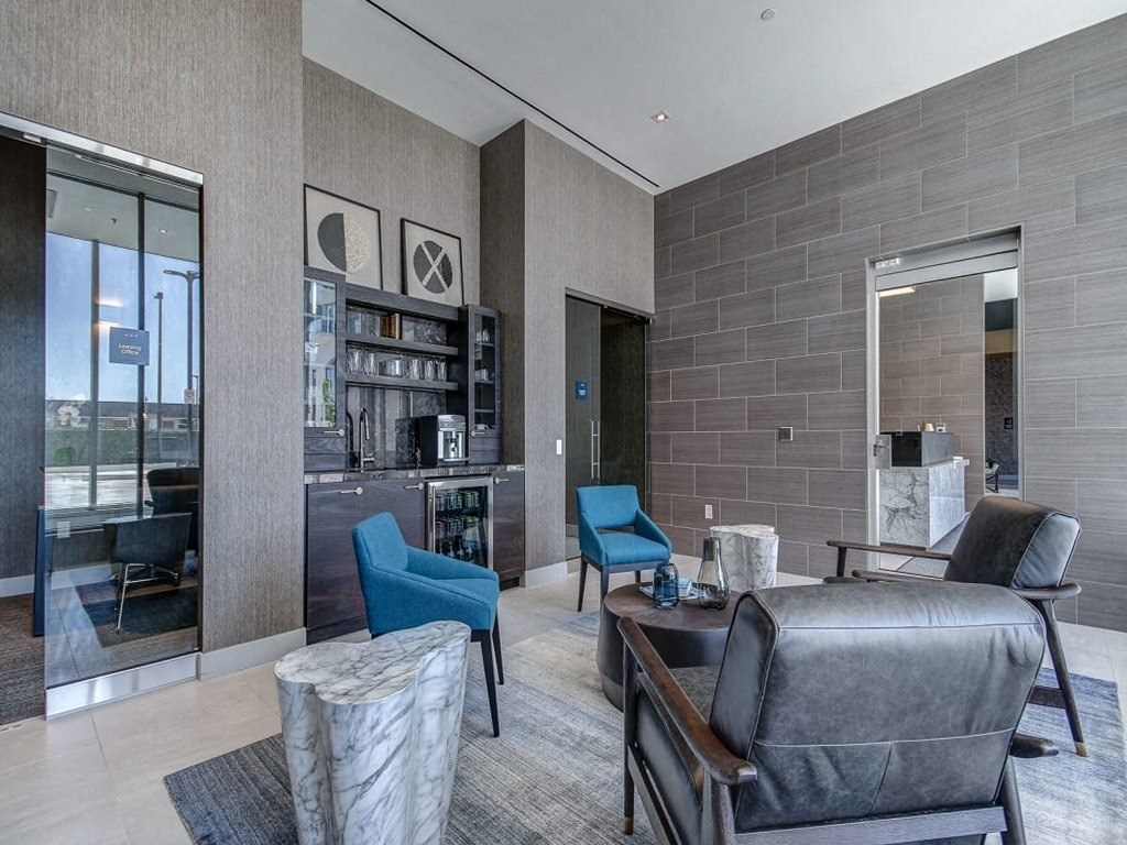 a living room with a couch and chairs and a tv at The Village, Oakville