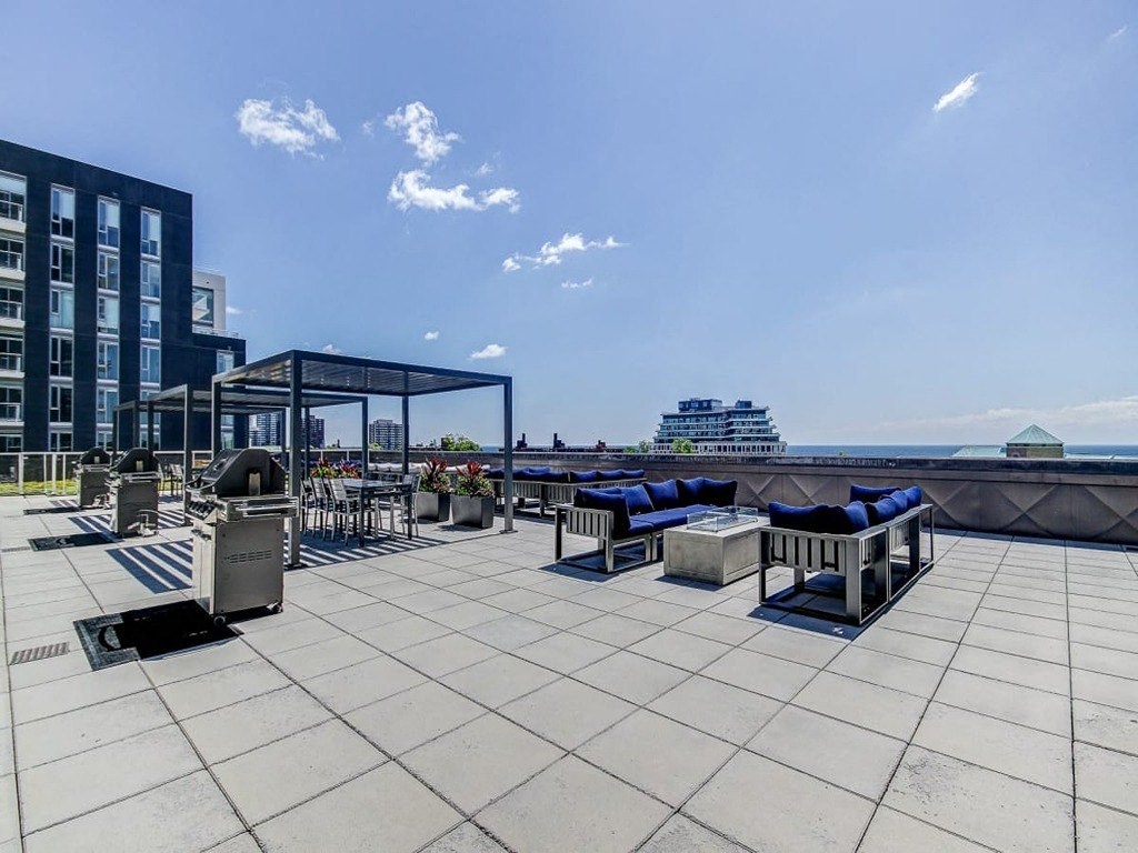 a group of people sitting on benches outside of a building at The Village, Oakville, ON
