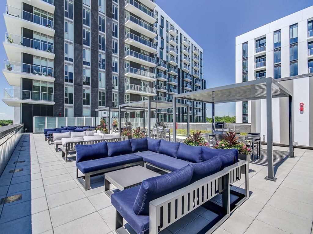 a communal area with couches and tables on a patio at The Village, Ontario