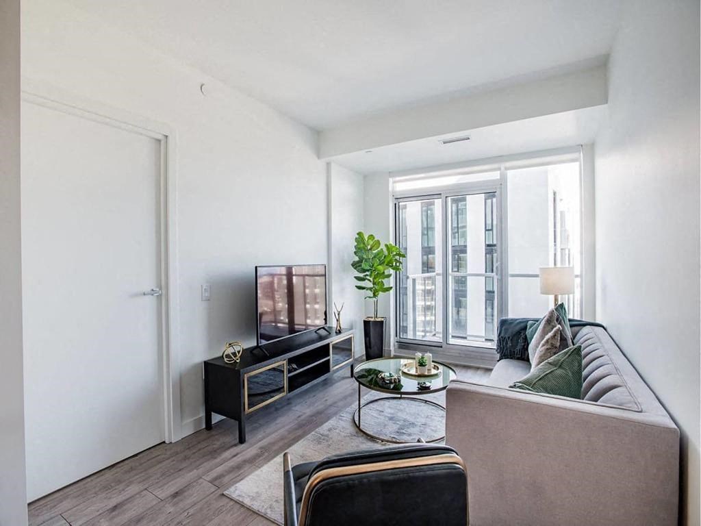 a living room with a couch and a tv at The Village, Oakville, L6L 0H1