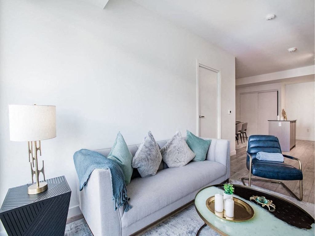a living room with a couch and a table  at The Village, Oakville