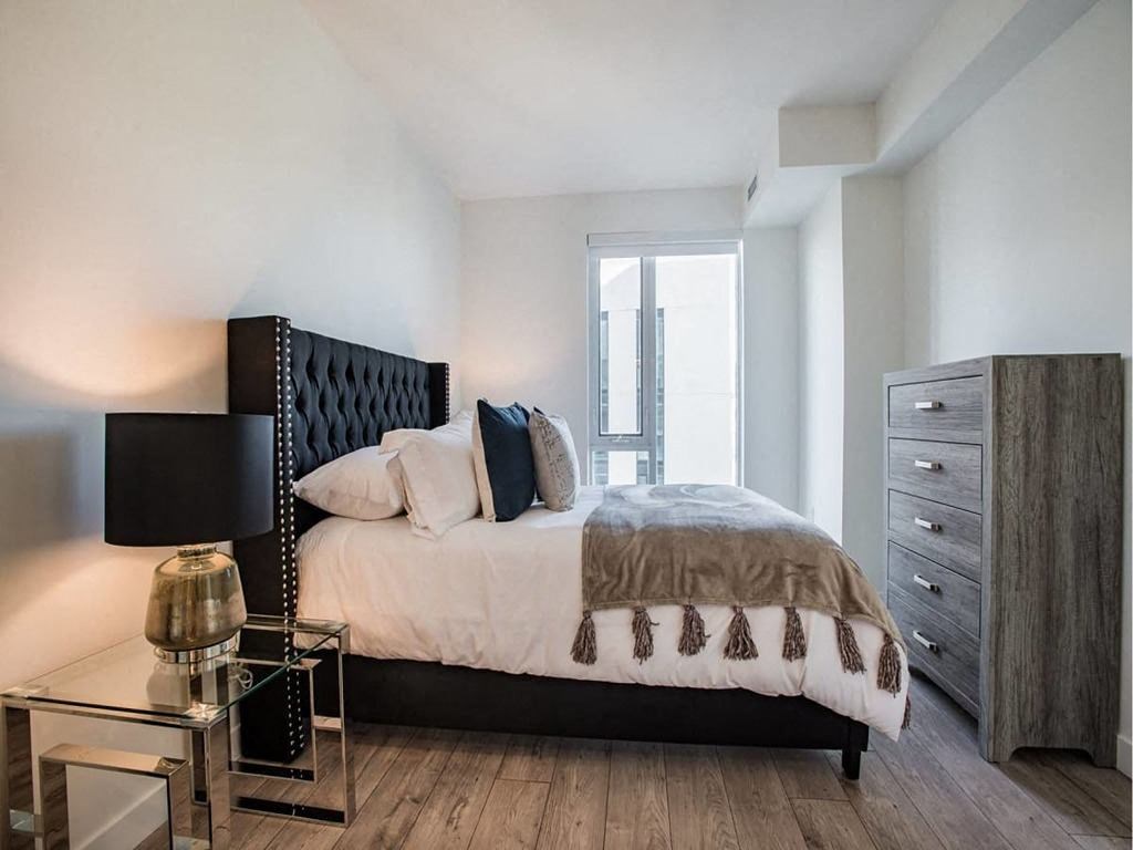 a bedroom with a bed and a dresser at The Village, Oakville, ON, L6L 0H1