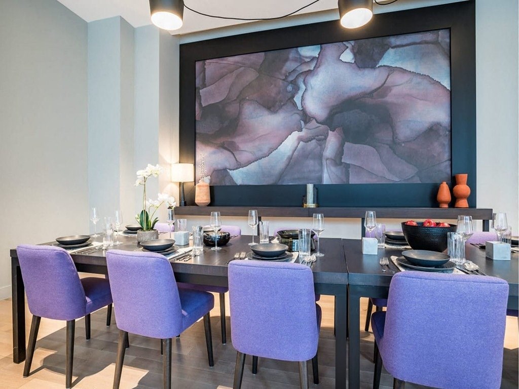 a dining room table with purple chairs and a large painting  at The Village, Oakville, L6L 0H1
