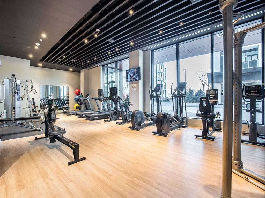the gym is equipped with a variety of exercise equipment  at The Village, Oakville