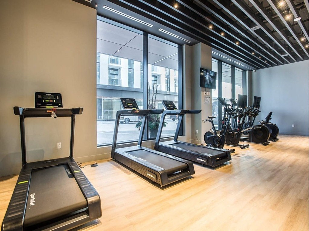 a gym with treadmills and other exercise equipment  at The Village, Ontario