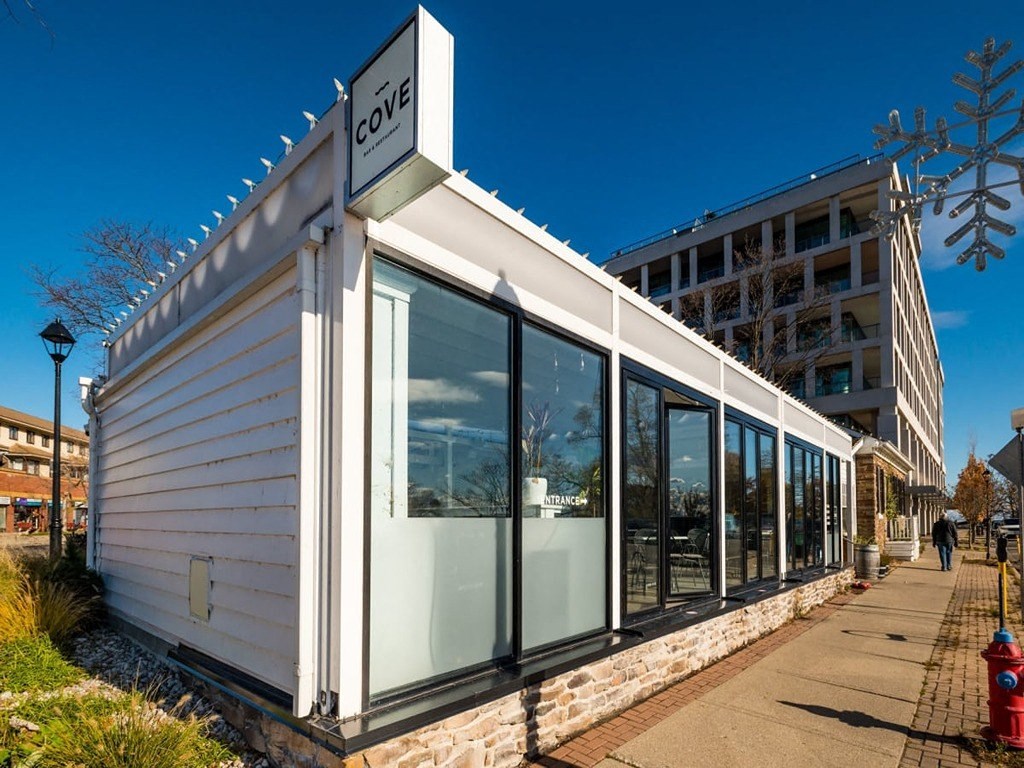 the facade of a cafe with large glass windows  at The Village, Ontario, L6L 0H1