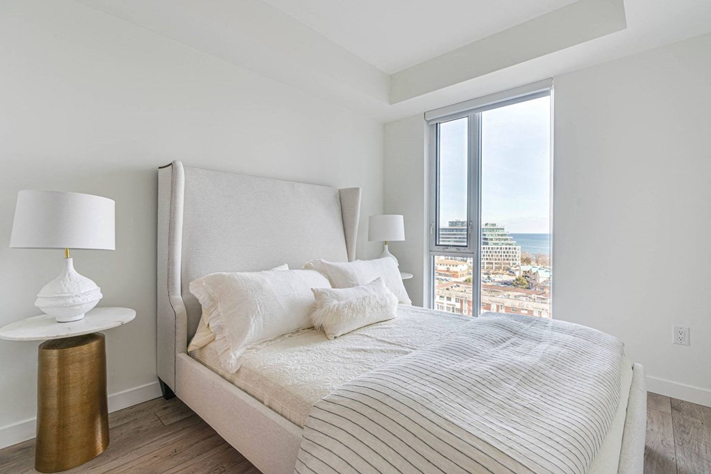 a bedroom with a large bed and a window