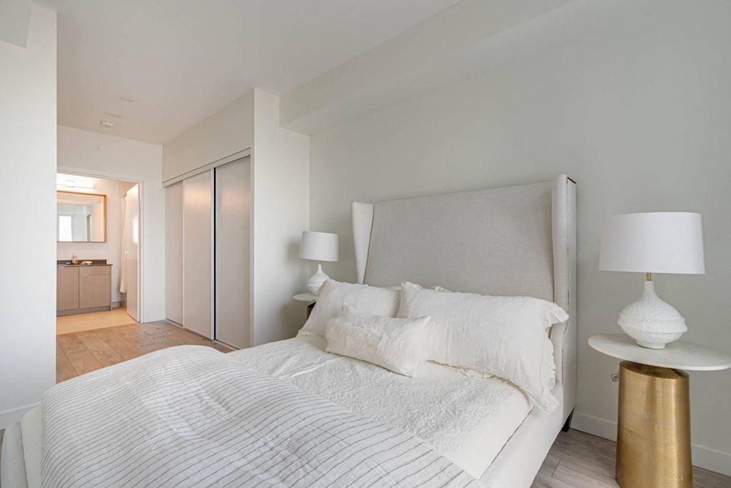 a bedroom with a large bed and a closet