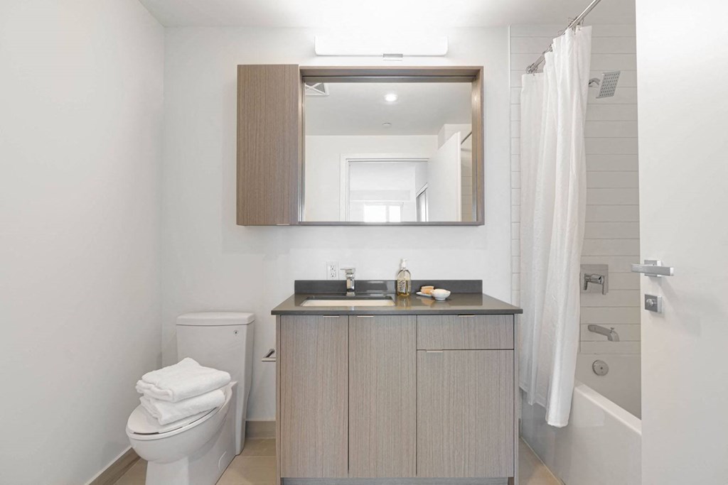 a bathroom with a toilet sink and a mirror