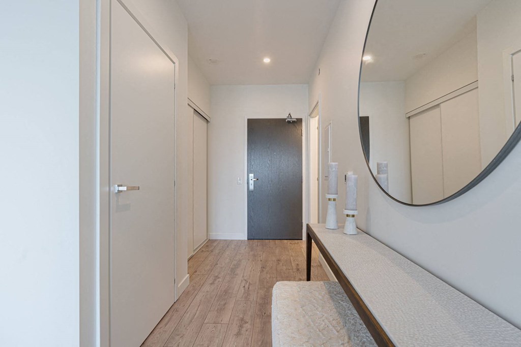 a hallway with a mirror and a door to a closet