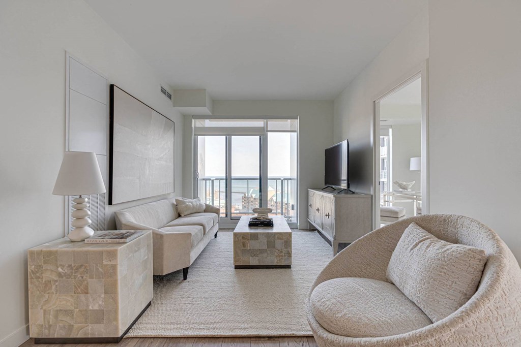a living room with a white couch and a tv