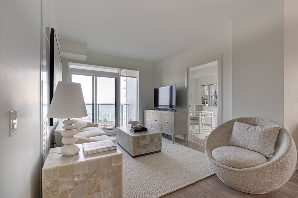 a living room with a couch and a chair and a television