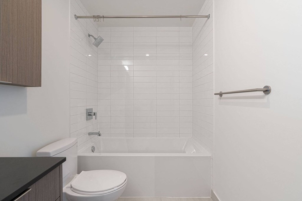 a white bathroom with a tub and a toilet