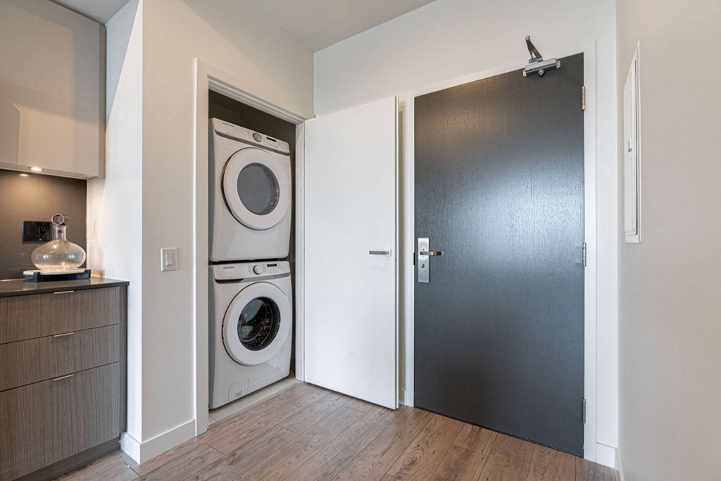 a door to a laundry room with a washer and dryer