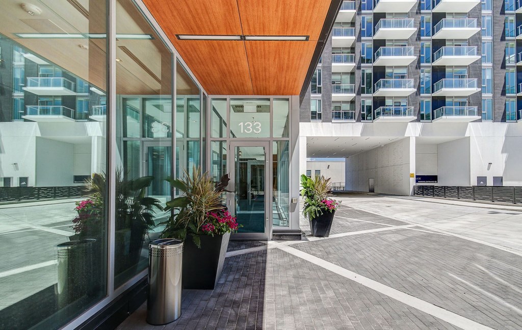 the entrance to a building with large glass doors and a courtyard