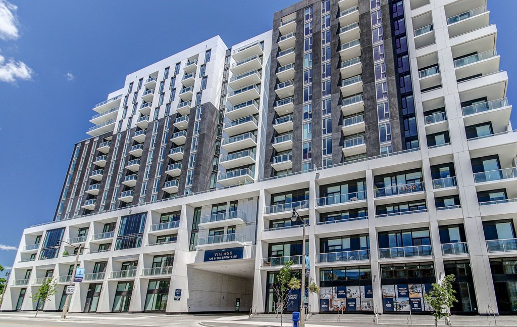 a large building with many windows and a street in front of it