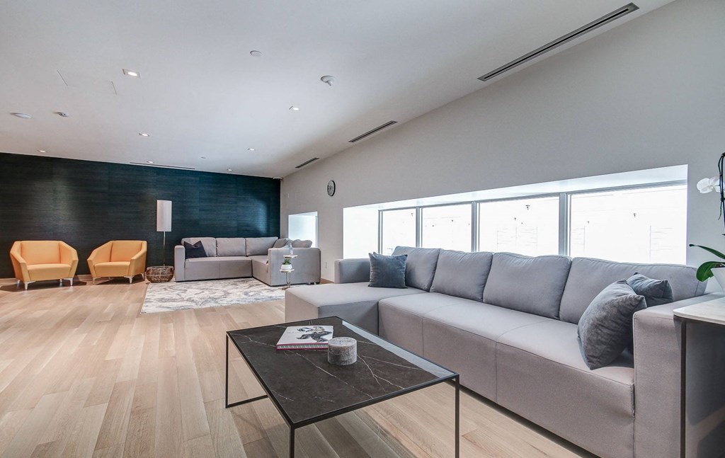 a living room with gray couches and a coffee table
