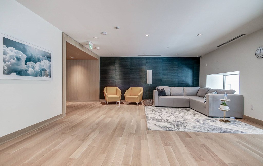a living room with a gray couch and a black accent wall