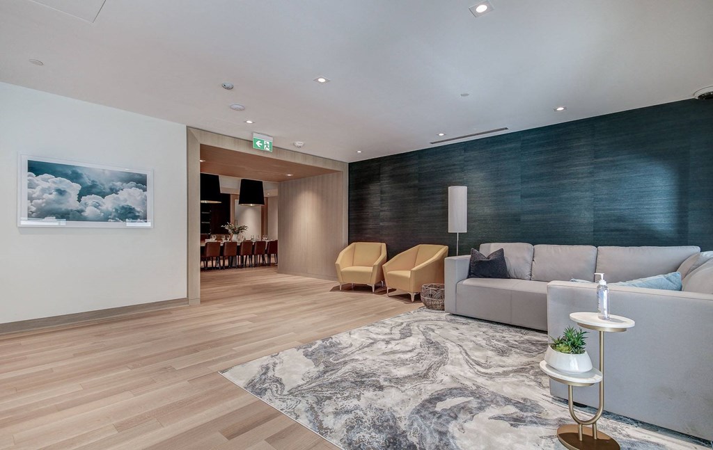 a living room with white furniture and a white rug
