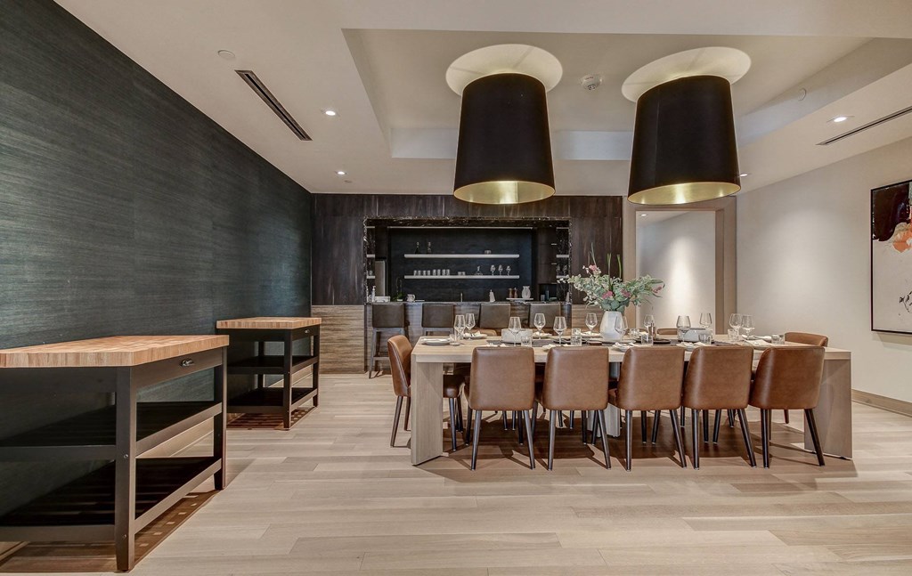 a dining room with a long table and chairs
