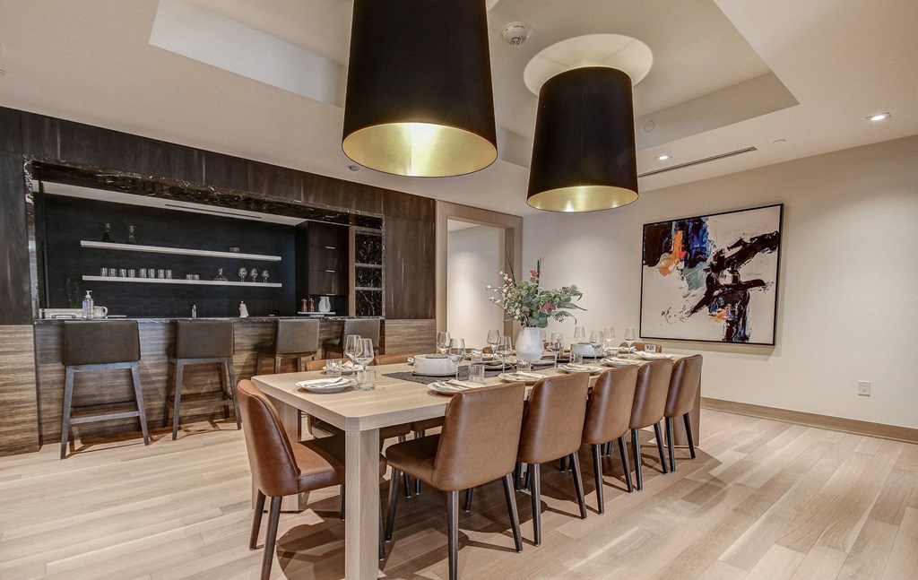 a dining room with a long table and chairs