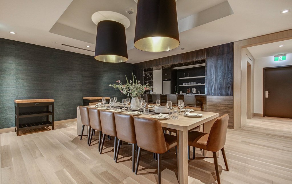 a dining room with a long table and chairs