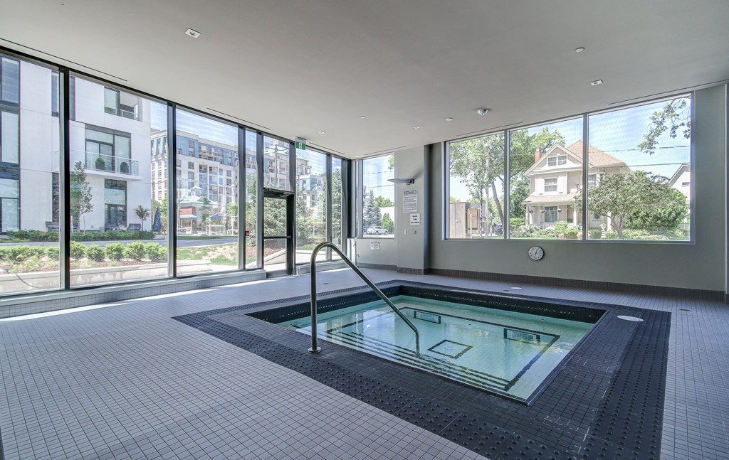 a jacuzzi pool in a room with floor to ceiling windows