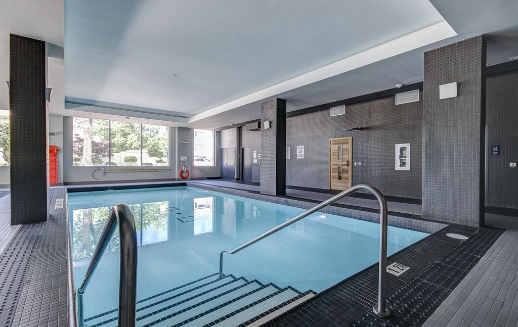 a swimming pool in a hotel lobby with a large window