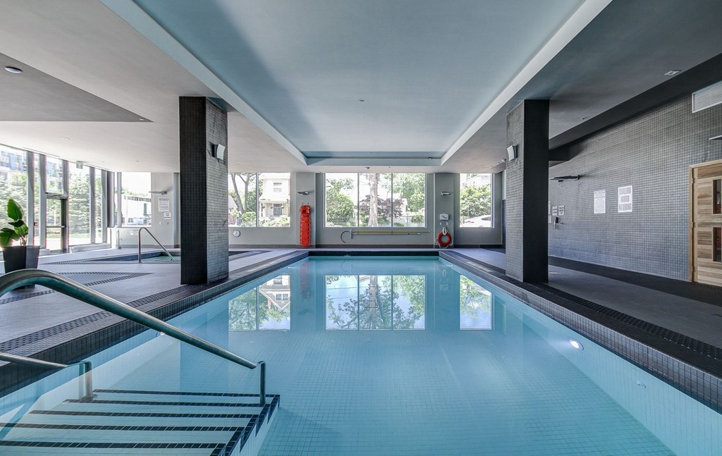 a swimming pool in a large room with a large window