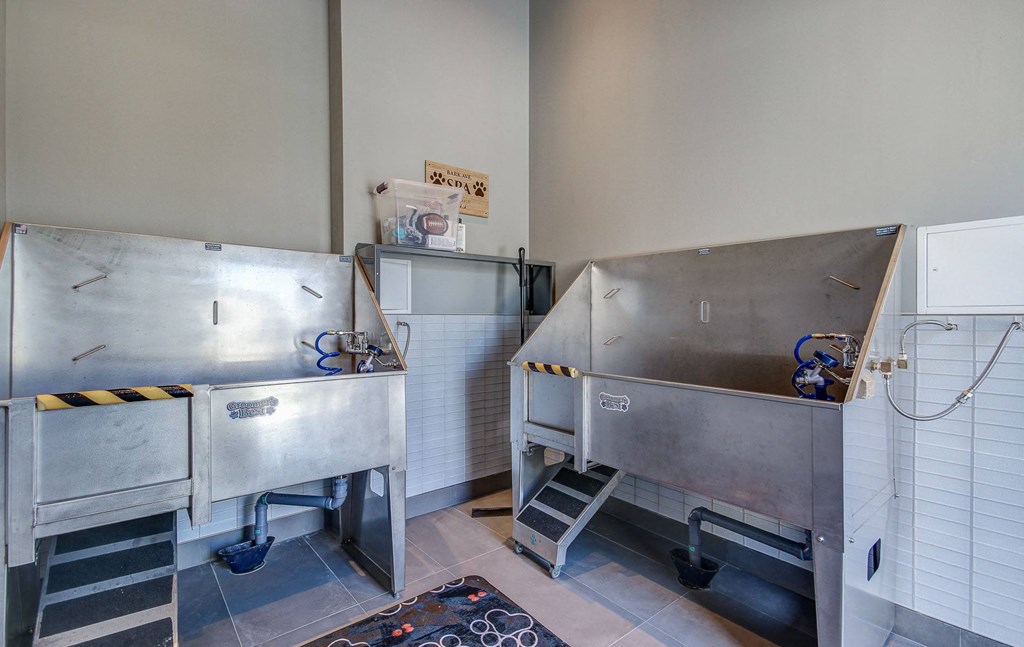 a kitchen with two stainless steel refrigerators and two sinks