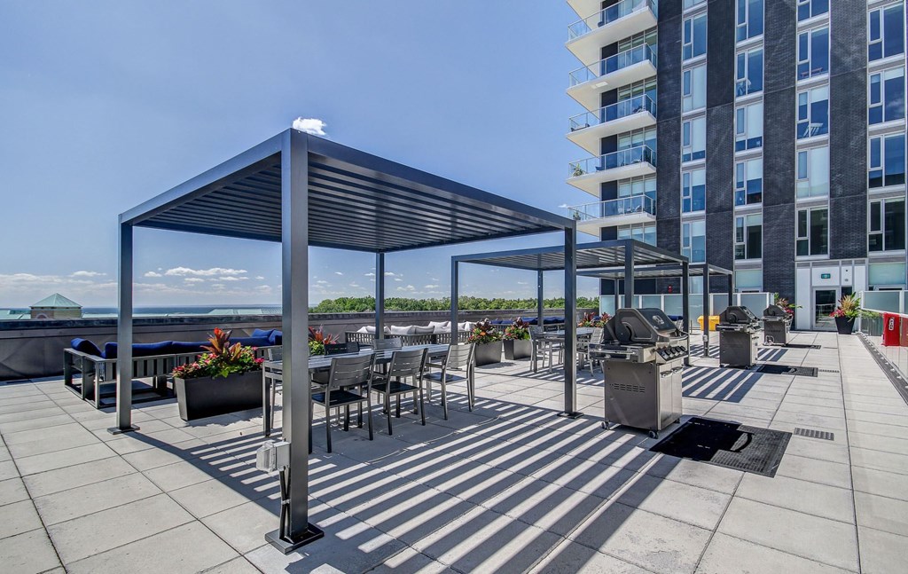an outdoor patio with tables and chairs and a large building