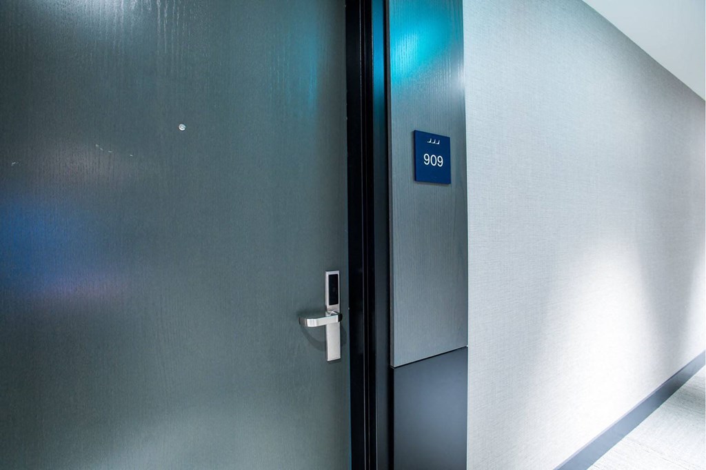 the door to an elevator with a blue sign on it