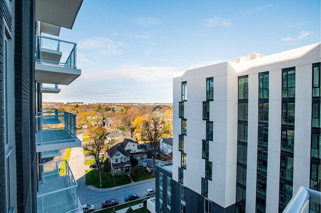 a view of the city from the balcony of a high rise apartment building