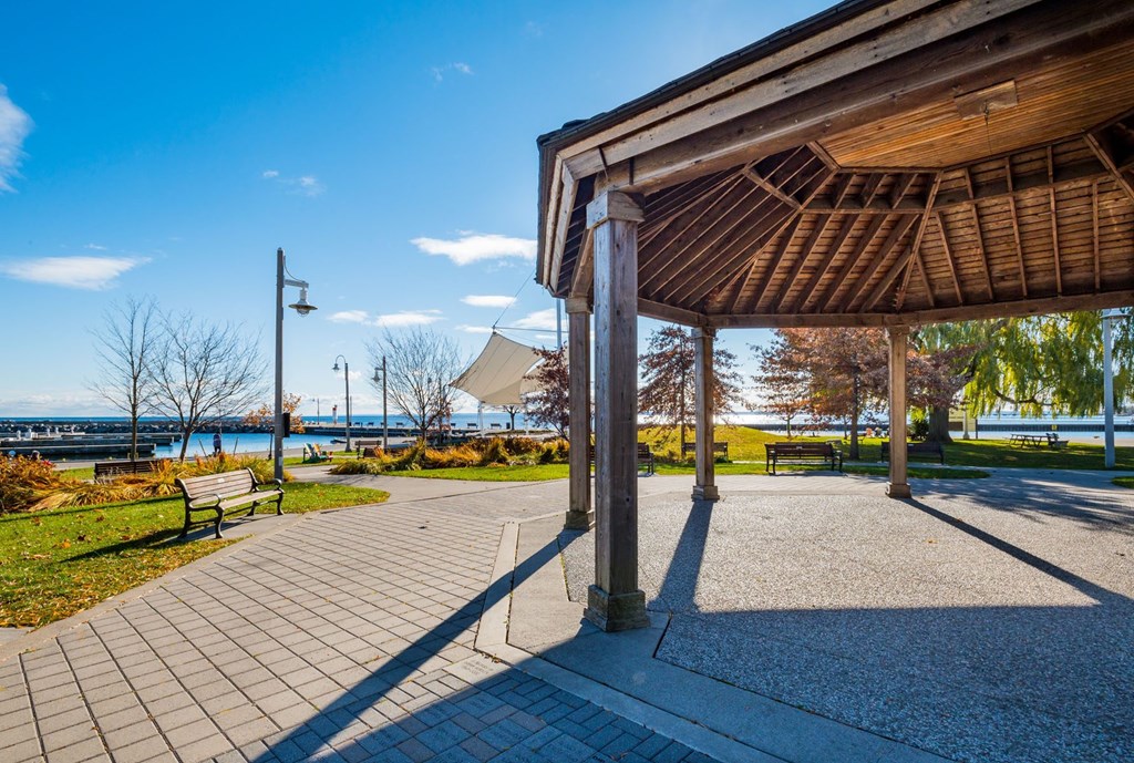 a pavilion with a view of the water in a park