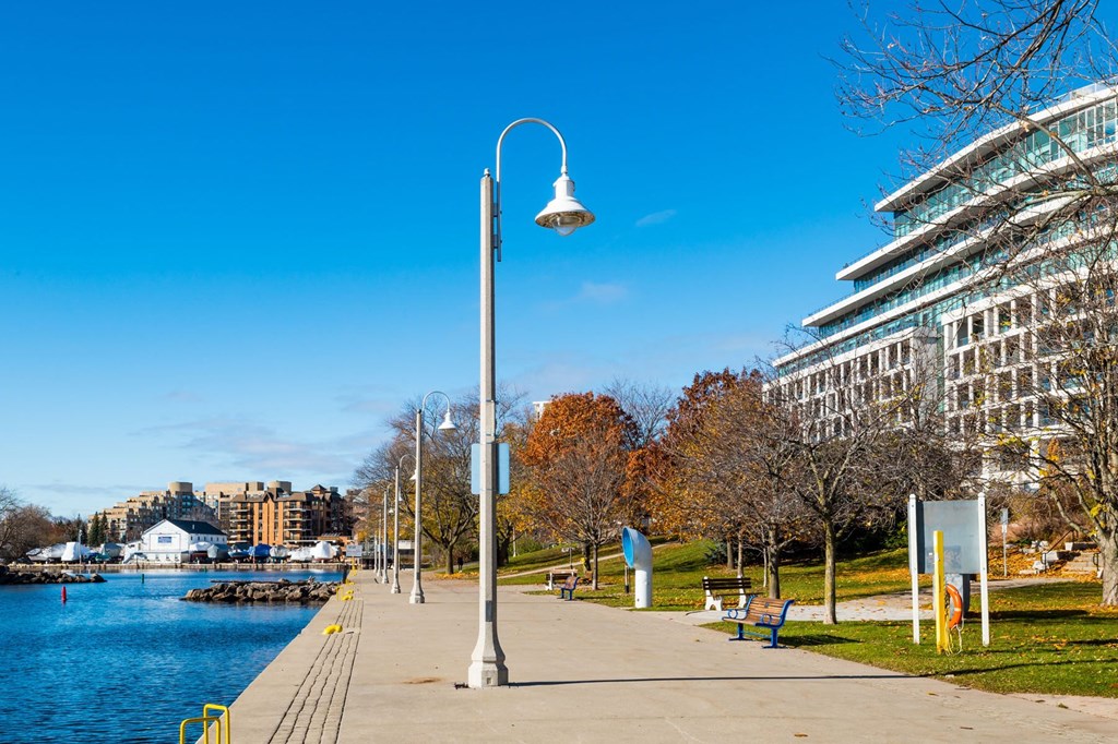a city park next to the water with a lamp post