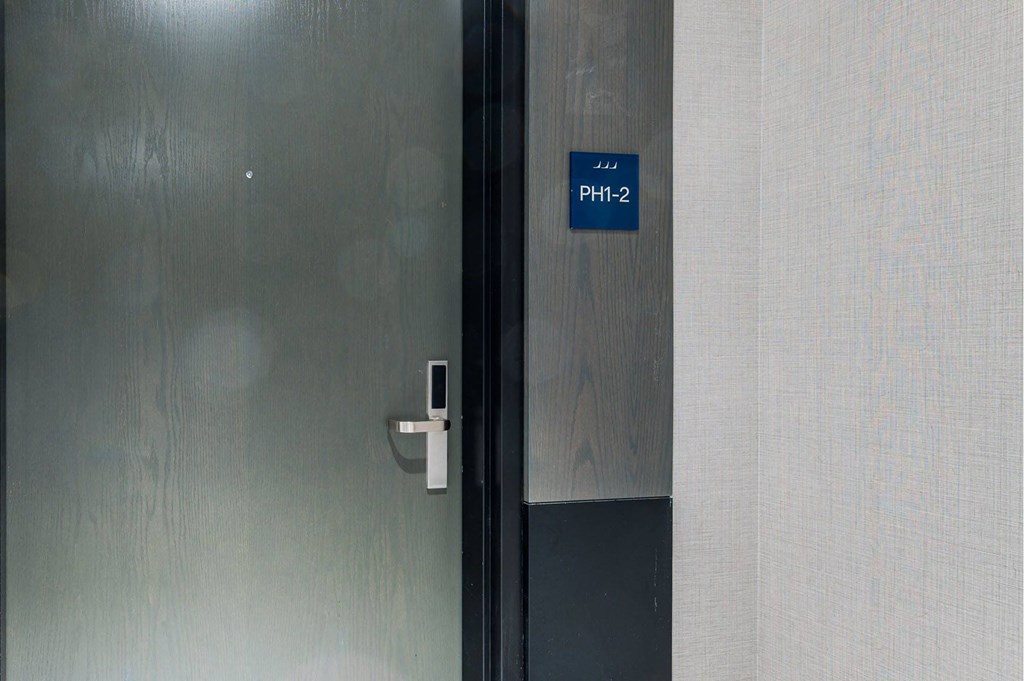 a door with a blue sign on it and a door handle